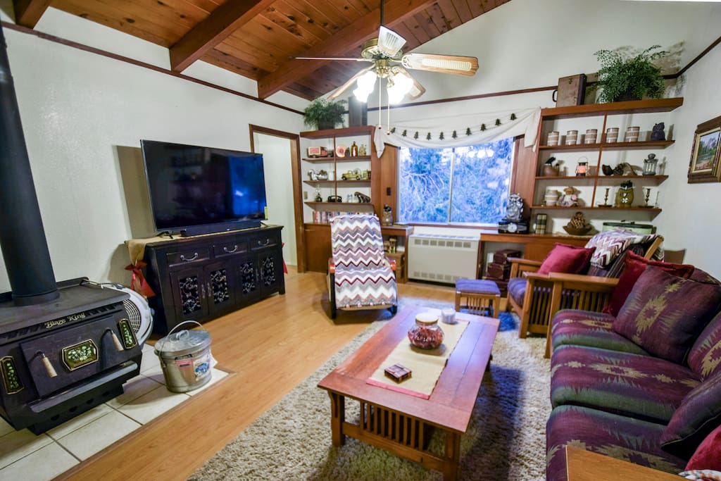 Living room with fireplace and propane wall heater, new 60" Smart TV, games, kid's corner & more!