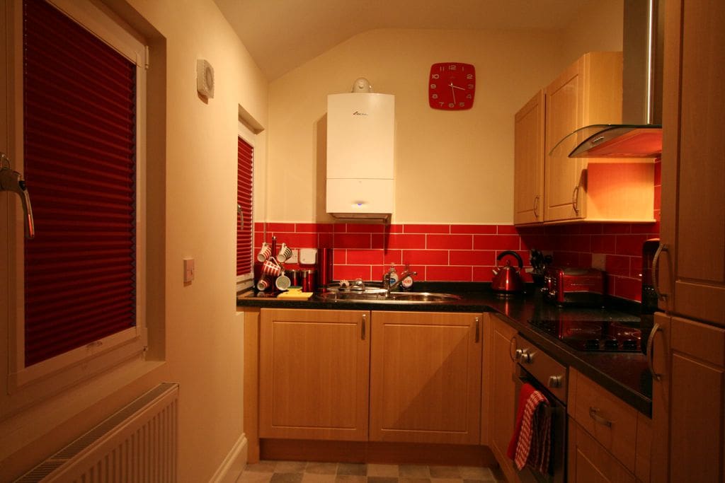 Full kitchen with fridge/freezer, electric hob and cooker, washing machine.
