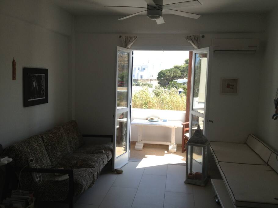 Living room and front balcony. A/C and a fan is there for the hot days