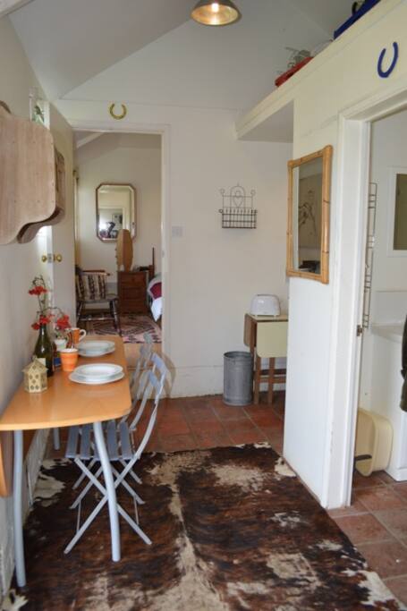 Kitchen then sitting room from bedroom door