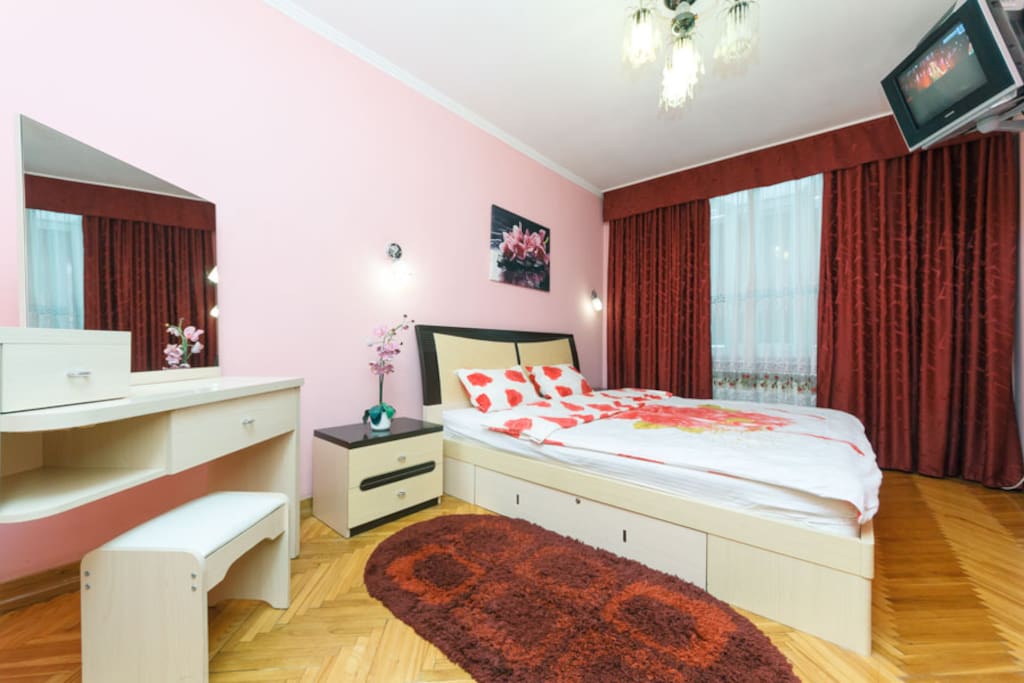 Separate comfortable bedroom, air conditioning, with "king" size bed, orthopedic mattress, cotton bed linen, towels, large wardrobe, bedside tables, TV on the wall in front of the bed, dressing table and chair in front of it.