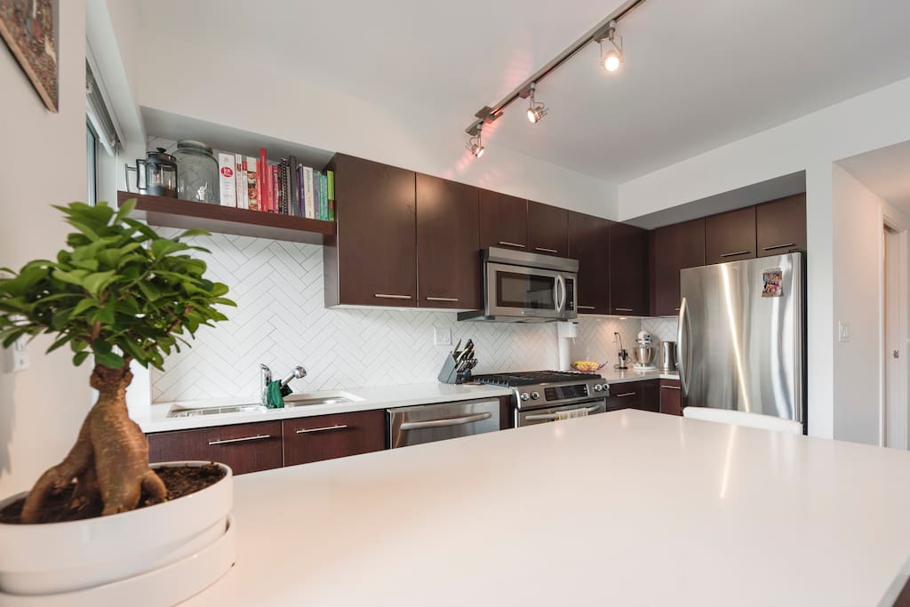 Bright, sunny kitchen is a pleasure to prepare meals in. Features dishwasher, gas stove, microwave and large refrigerator.