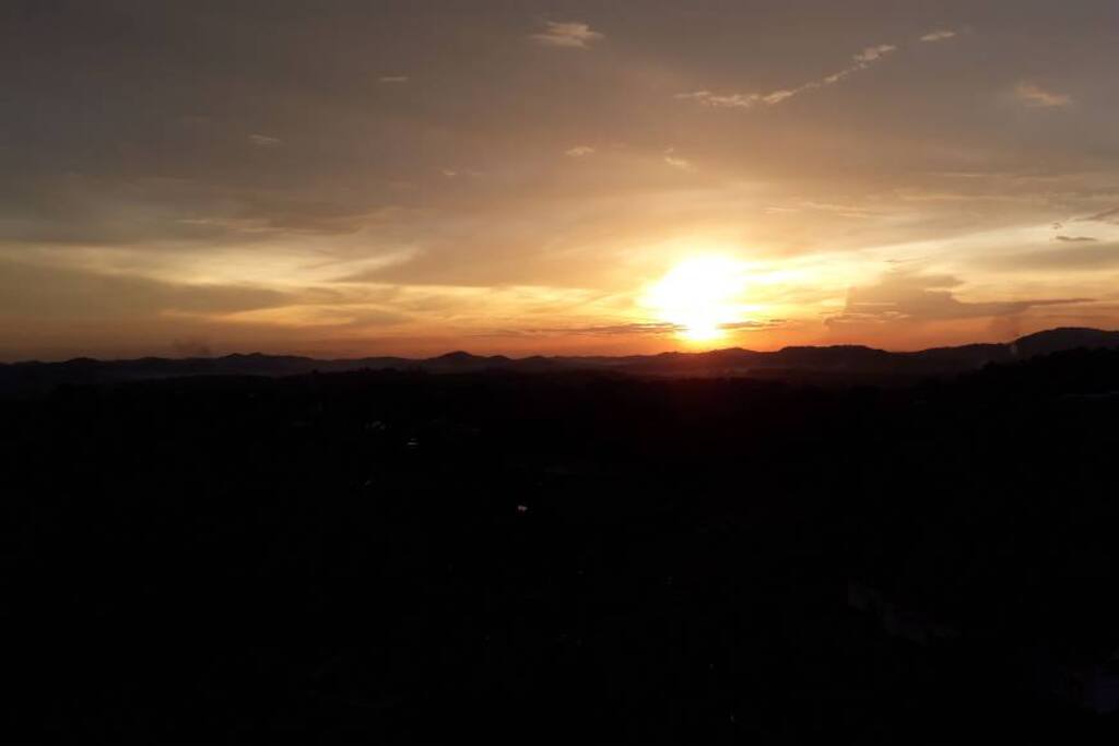 A view of the sun setting seen from the balcony