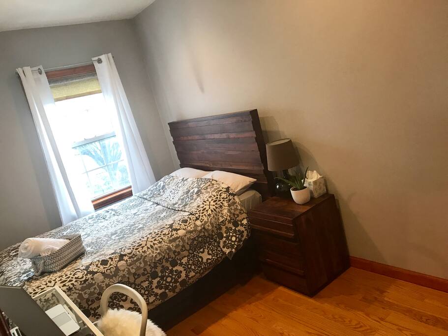 Simple and cozy bedroom with bed & nightstand made from solid saal wood highlighting the natural grains of the wood adding rustic charm to the room...extra comfortable mattress