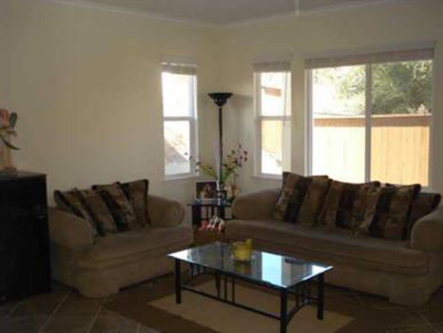 Living room...furniture and paint have been updated. There are also drapes.