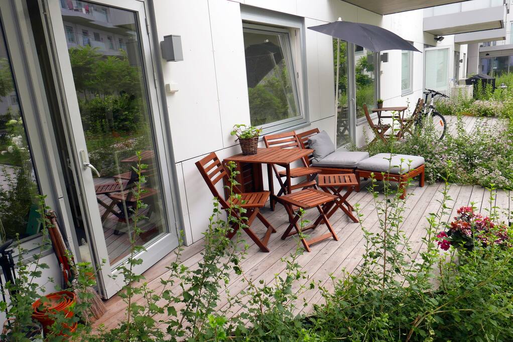 Our apartment got a front terrace equipped with furniture and pillows, a sun bed and a parasoll. Perfect for enjoying a meal in the sun.