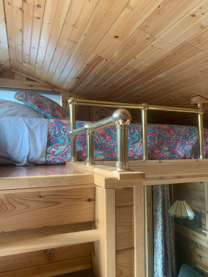 A small loft with a twin mattress. Steps to get up to it.