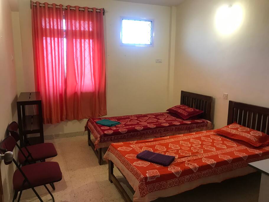 Bedroom with two beds and one work table