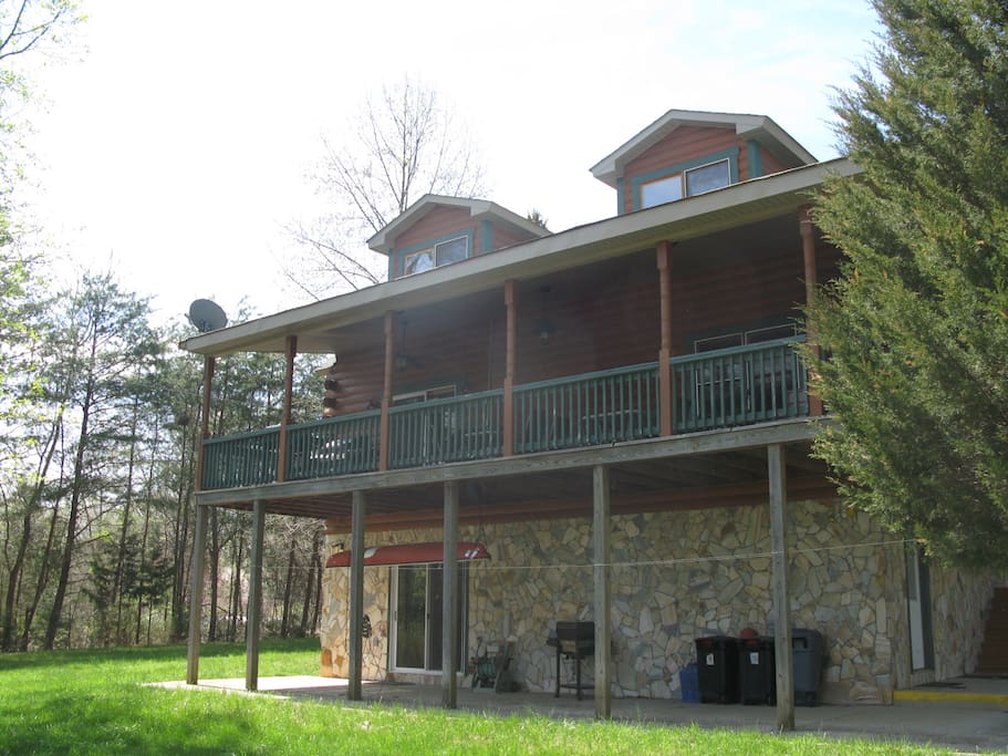 Back of house with beautiful lake view, fire fit area with picnic table
