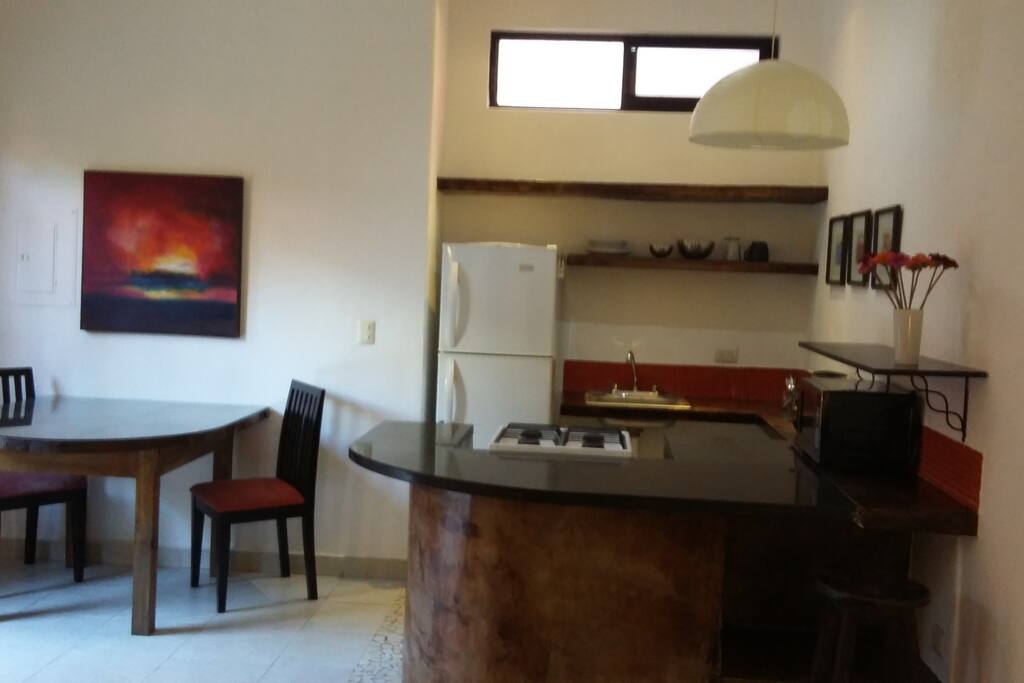kitchen breakfast bar next to two person dinig table