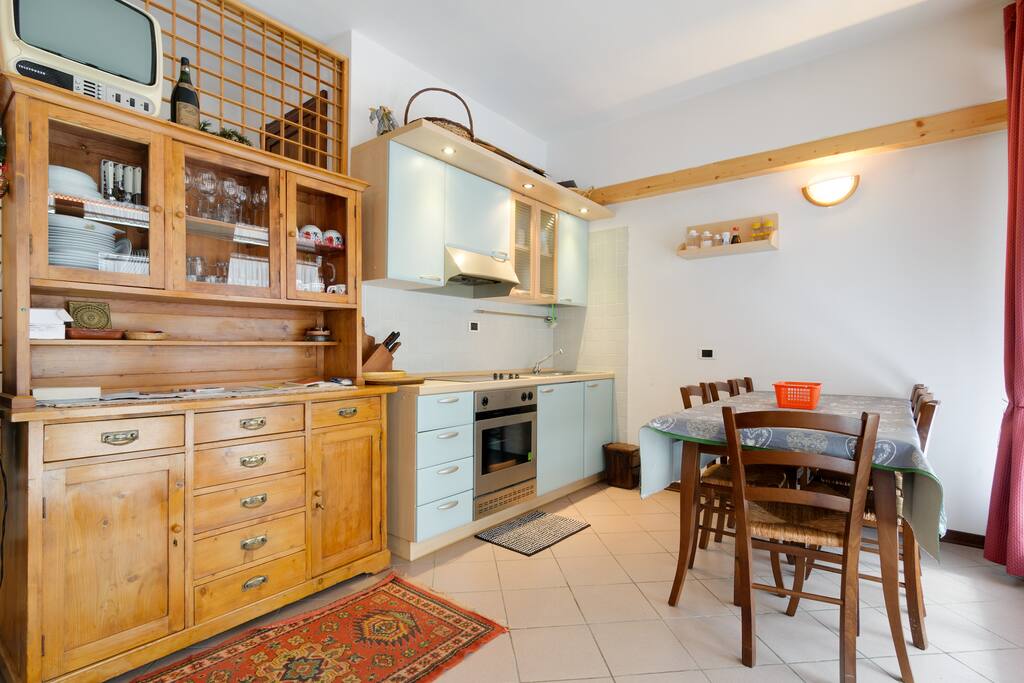 Cucina e parte del soggiorno. La cucina può comodamente ospitare a tavola 6 persone e se necessario anche 8.