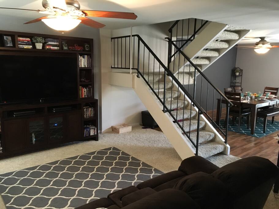 Living and dining room, stairs leading up to 3 bedrooms and 2 bathrooms.