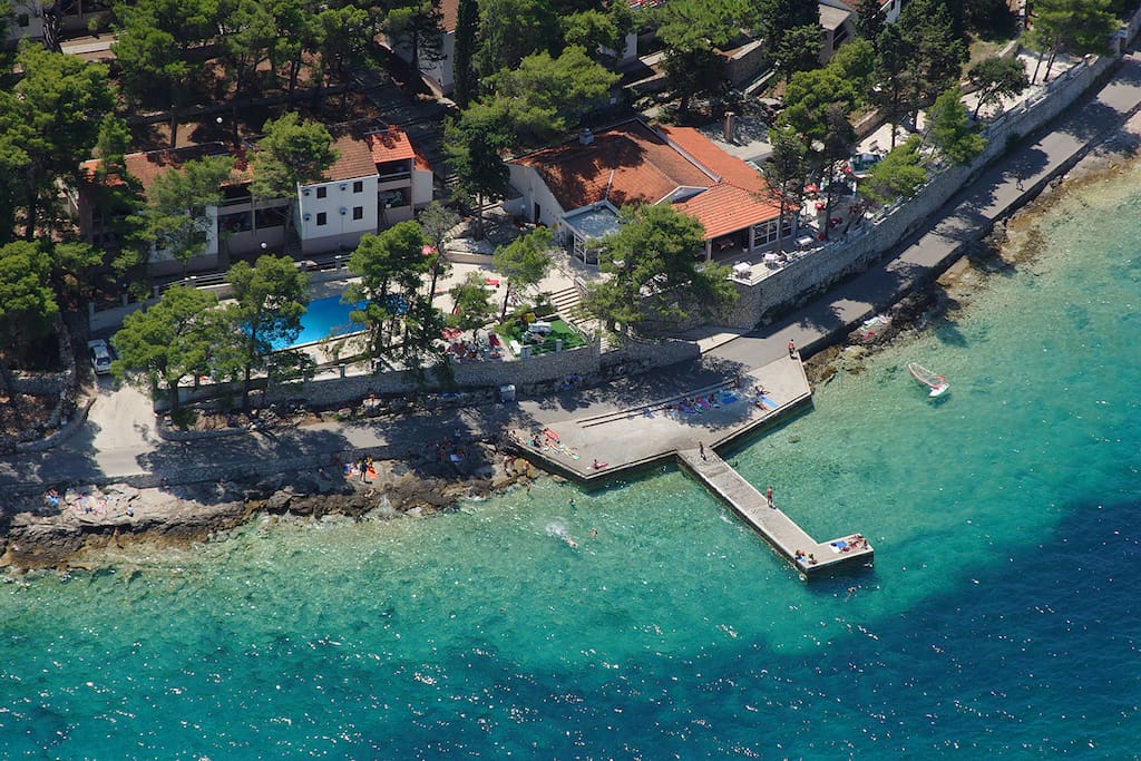 Aerial view. Our apartments can be seen here with their prime position overlooking the sea.