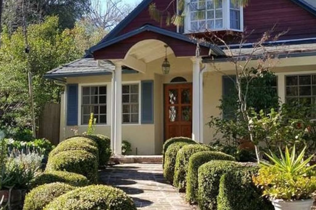 Front walk thru beautiful front yard.
