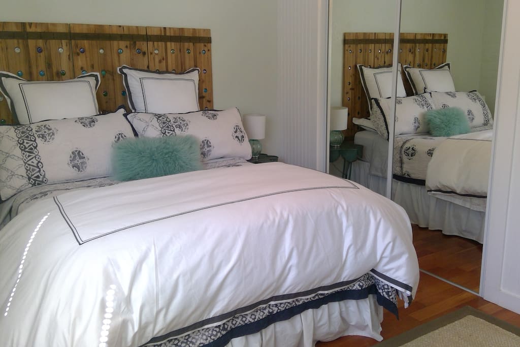 Master bedroom with Luxury linens, full size closet, pillow top queen bed mattress, cherry wood floors. Master bedroom. Colors and furniture decorated to create a quite restorative room