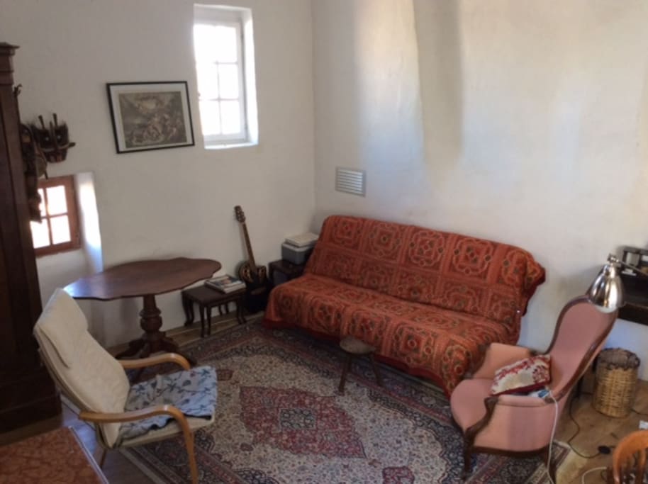 living room, windows front and back. Opens to terrace