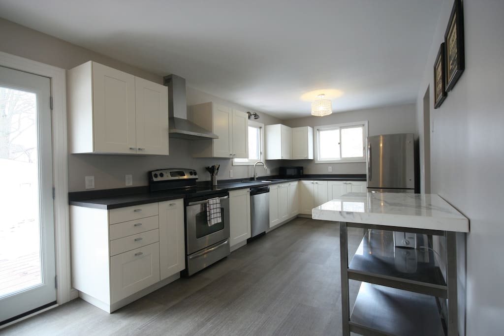 Prepare your meals in this bright, newly renovated kitchen with stainless steel appliances and marble top island. Bonus - BBQ and eat outdoors in the large wrap around patio deck just outside the patio doors!