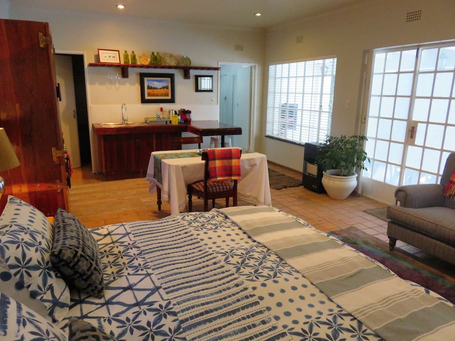 The living space with doors off to pantry/ storage room and en suite bathroom with shower