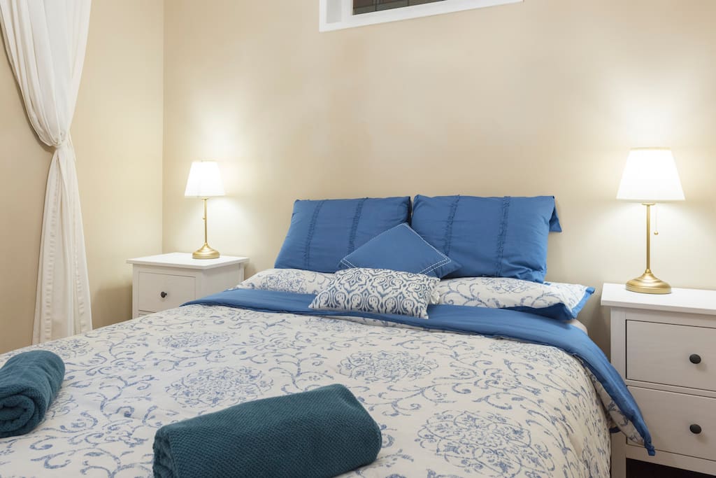 Master Bedroom with 2 bedside tables and lamps. Large wardrobe with hangers.