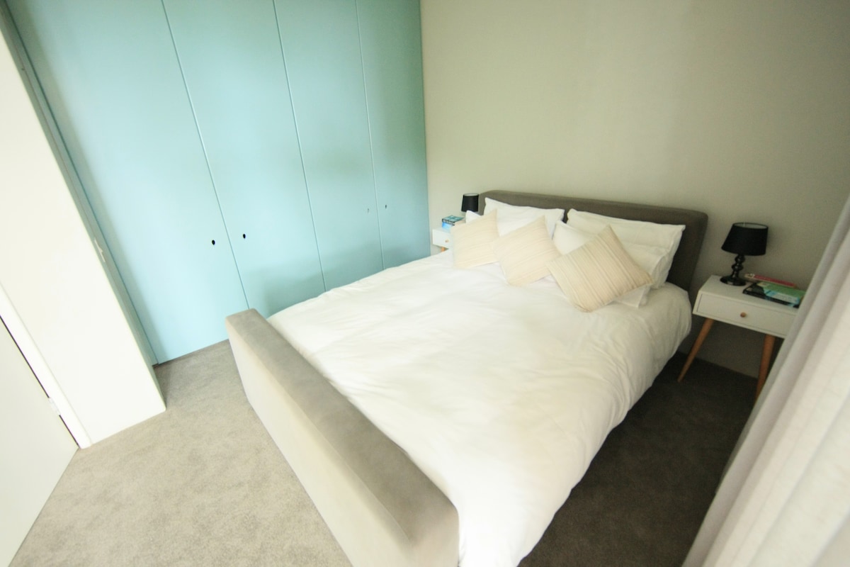 garden bedroom with queen bed and ample cupboard space