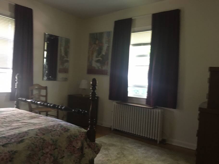 Guest bedroom with windows to the back and side yards