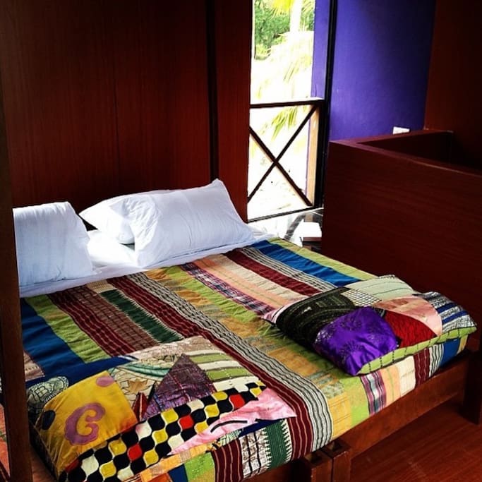 Double bed with traditional woven silk spreads