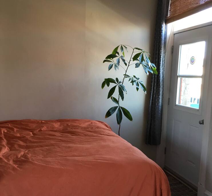 The beautiful front bedroom has a raised queen sized bed and access to the balcony.