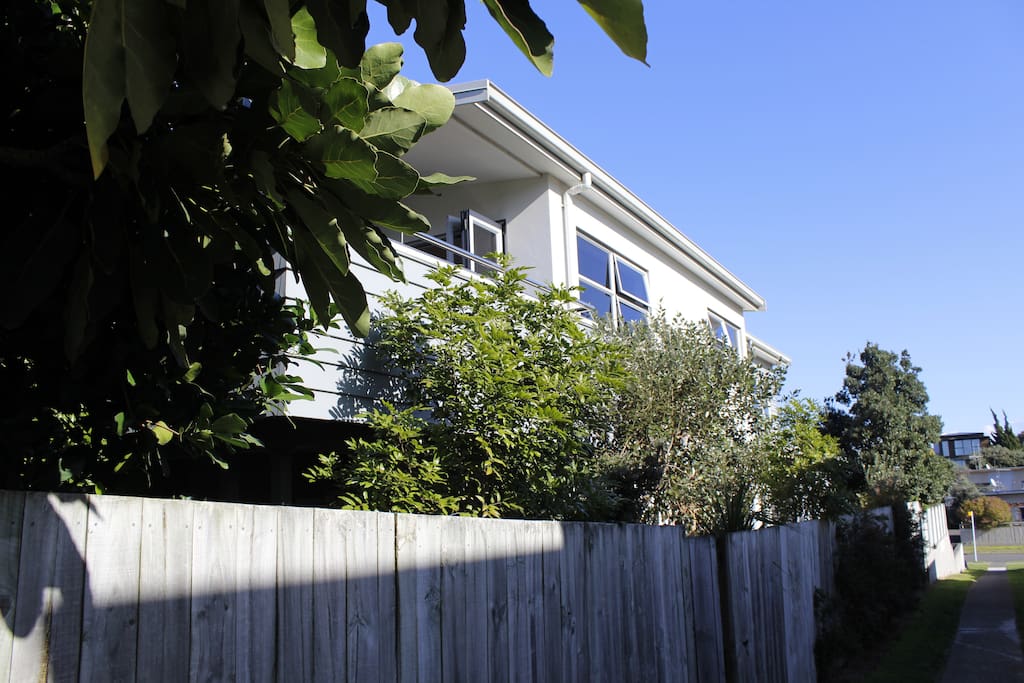 View of home with walkway access through private gate.
