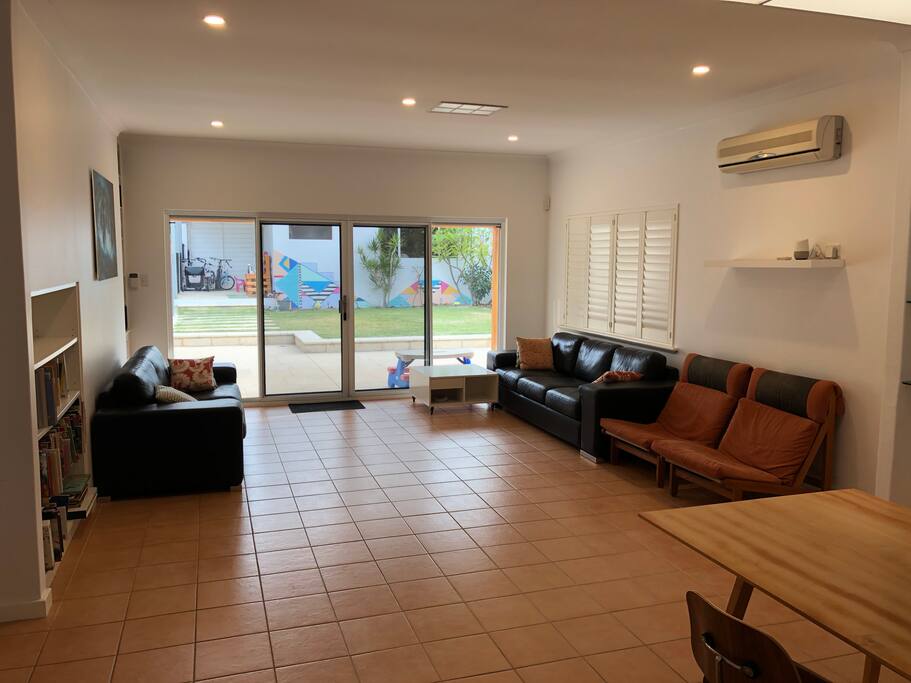 Big living room looking to outside living and dining area.