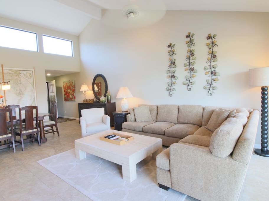 Inviting family room with goose down filled chenille sectional, travertine coffee table and Crate and Barrel chair.