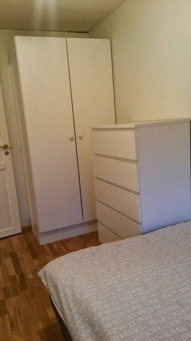 Bedroom with queen size bed, closet and drawers