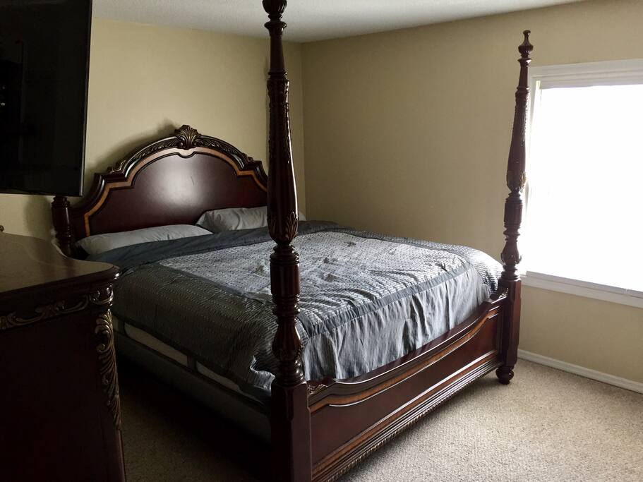 This bedroom features a comfy king sized bed with a wall mounted 43" smart tv! There is also closet space and empty dressers for belongings.