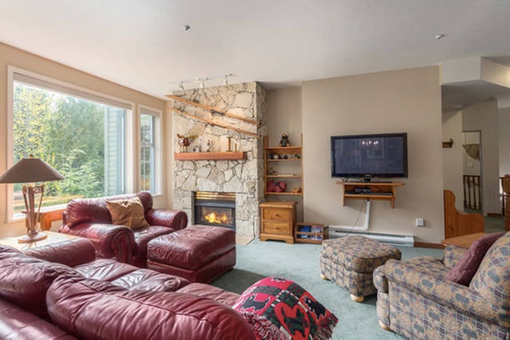 Open concept living room with gas fireplace and great natural light