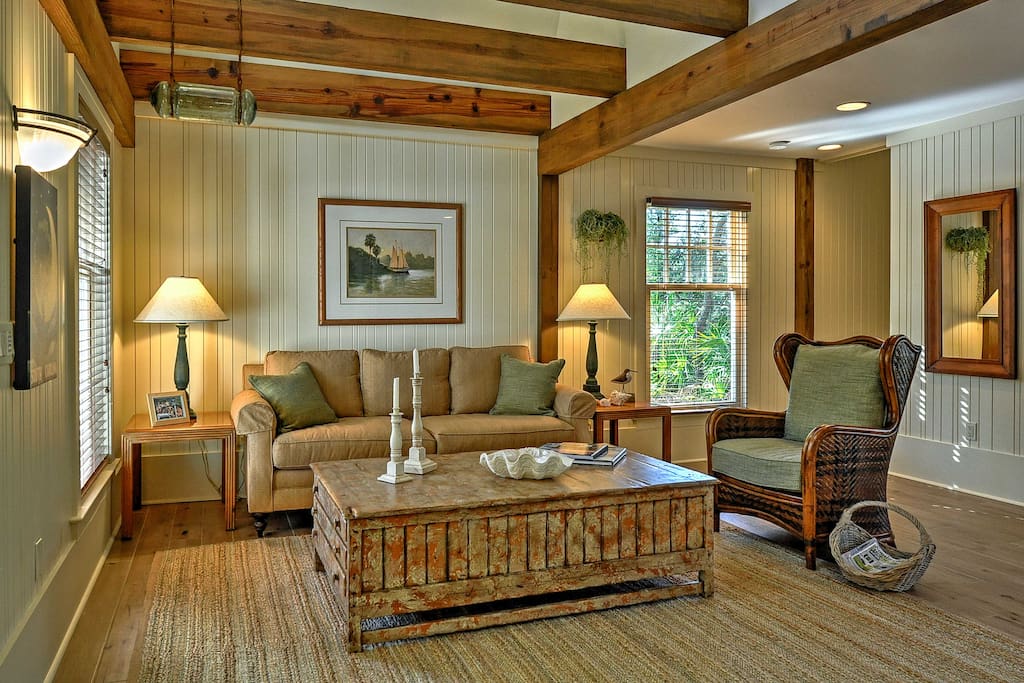 Unwind in the open-concept living space, featuring exposed wood-beam ceilings.