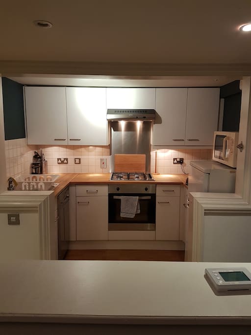The kitchen, including gas hob, electric oven, dishwasher, microwave and fridge freezer