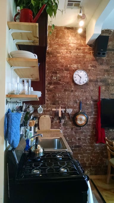 We love our hand-made kitchen shelves and, of course, the brick wall.