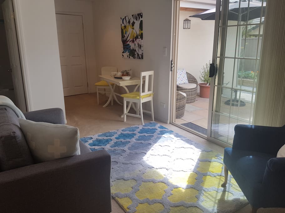 Seating area leading into sunny courtyard