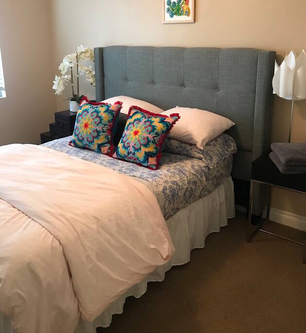 Full/double size bed with down pillows and duvet. On top level.