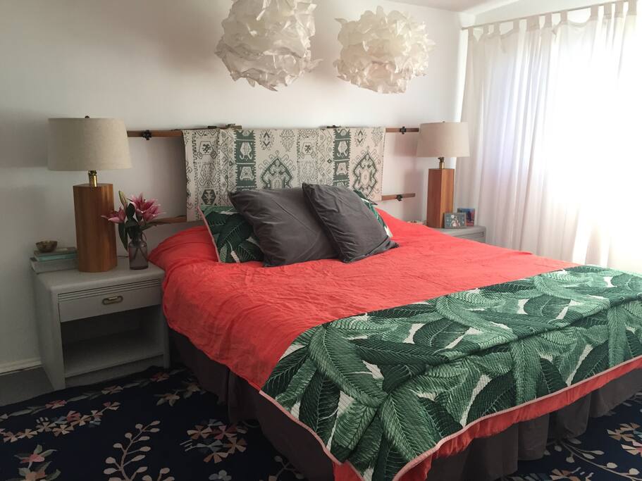 the master bedroom with king sized tempurpedic bed and upcycled military cot headboard.