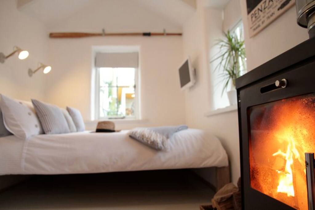 Comfy double bed with vintage reading lamps, wall-mounted TV/DVD player & roaring woodburner (logs included with your stay)..