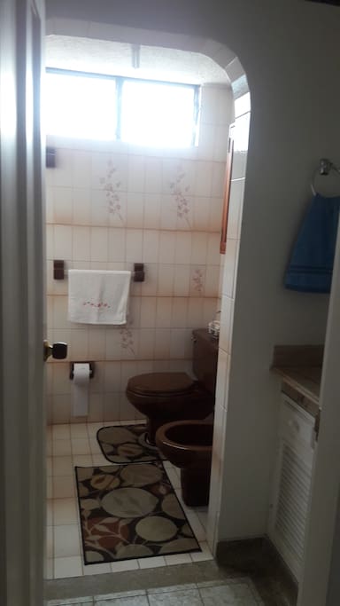 Baño con sanitario, lavamanos y tina-ducha
