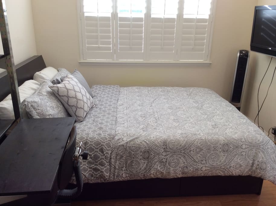 The room includes a wall mounted TV.