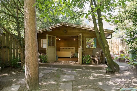 Cozy garden house in green oasis near city center