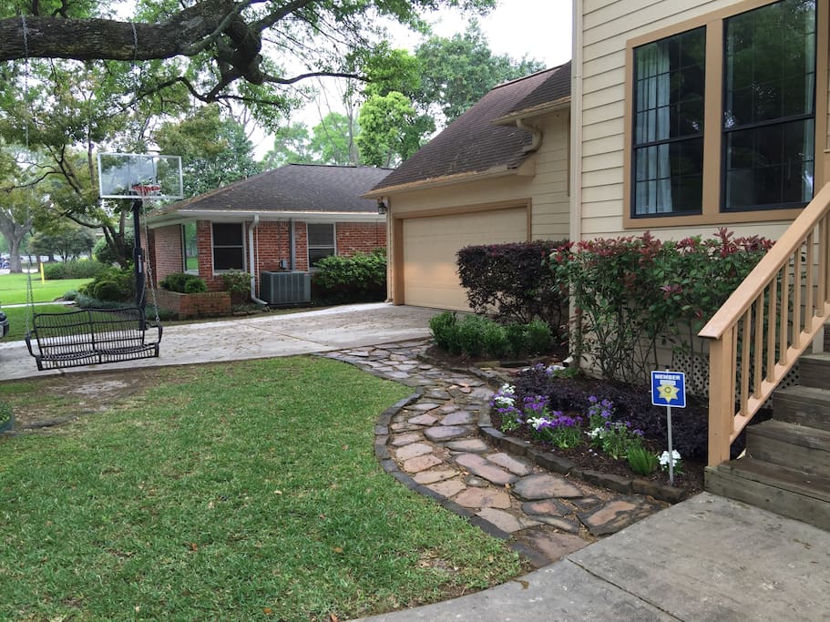 Front yard with basketball goal and swing