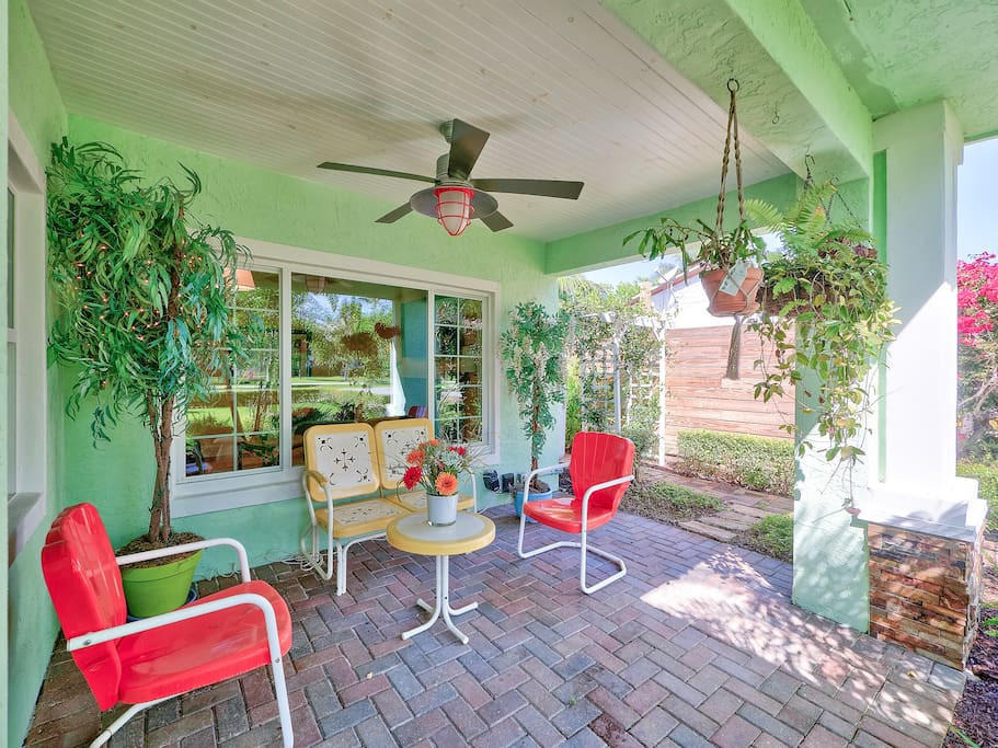 Sip morning coffee on the charming front porch lined with potted plants.