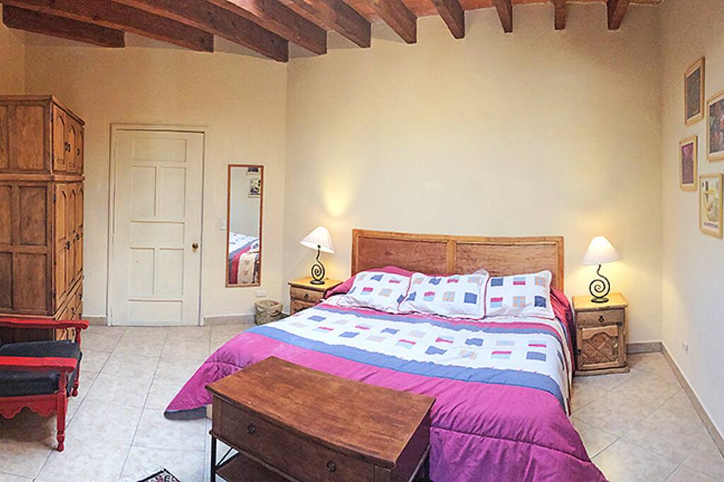 Bedroom with large armoire to the right.