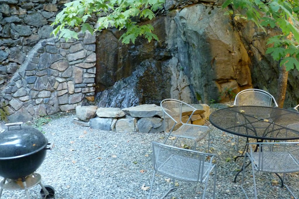 Backyard patio and small relaxing waterfall feature.