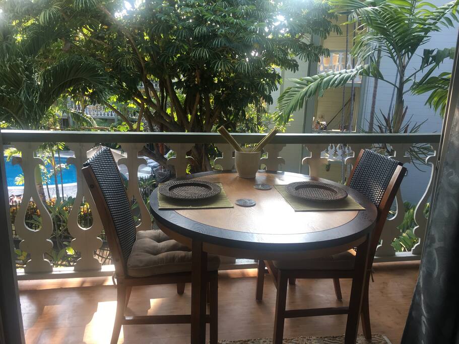 Outdoor dining on private patio overlooking the pool