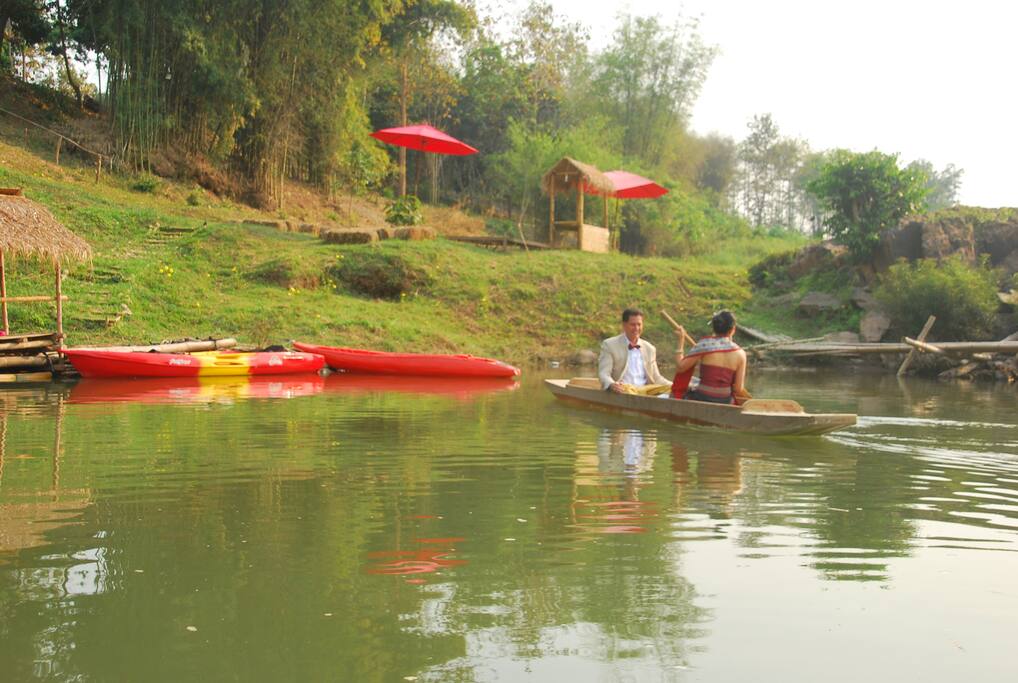 River access with kayaks and bamboo huts for lounging