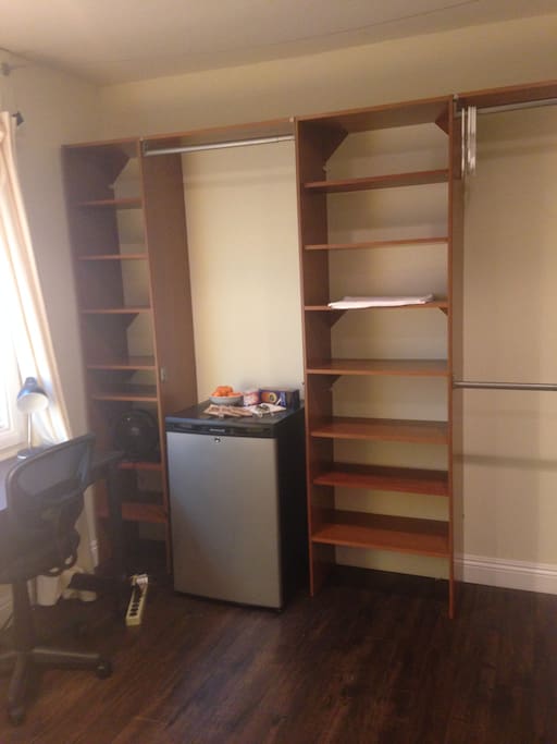 Built in shelving with refrigerator and plenty of room for your belongings